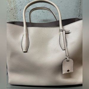 Kate Spade purse. Light Pink. Small area that is missing leather (see picture)